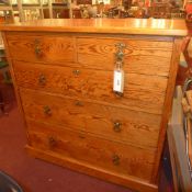 A Victorian pitch pine chest fitted two short and three long drawers with brass handles on plinth