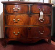 An early 19th century mahogany bowfront chest fitted two short and two long drawers on splay