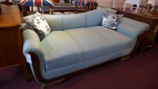 A 20th century German oak two seater sofa upholstered in pale blue woolen fabric.