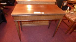 A 19th century walnut card table the foldover top above end drawer and raised on square tapering
