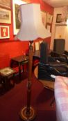 A Stained beech reeded standard lamp with silk shade.