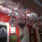 A Venetian glass chandelier with turquoise and pink tinted detail,