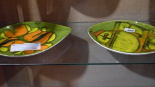 A pair of oval green glazed Poole pottery dishes.