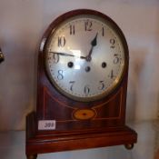 An Edwardian inlaid mahogany dome top mantel clock with steel convex dial, key and pendulum.