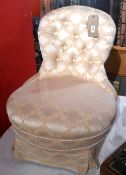 A Victorian nursing chair upholstered in buttoned gold foliate dunmask raised raised on castors.
