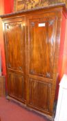 A late 19th century Chippendale style carved mahogany wardrobe fitted pair of panel doors enclosing