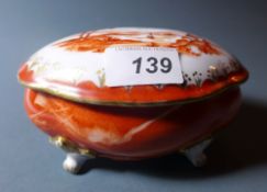 A French porcelain lidded trinket box decorated with landscape scene and heightened in gilt,