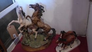 A Beswick style horse figure group together with another similar resin group (2).