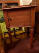 A 19th century French fruitwood pot cupboard fitted single panel door and raised on turned tapering