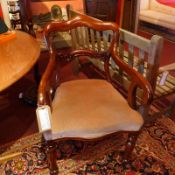 A Victorian mahogany armchair with stuffover seat upholstered in beige velour and raised on turned