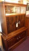 A retro mid 20th century Macassar ebony and oak side cabinet having pair of sliding doors above two