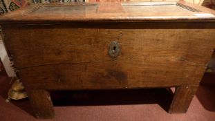 A 17th century oak coffer / marriage chest with heavy panelled rising top and raised on tapering