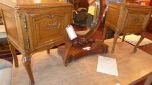 A pair of French carved oak bedside cabinets fitted single panel door and raised on cabriole