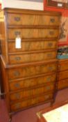 A 1920's walnut chest on chest fitted eight drawers with brass plate handles on squat cabriole