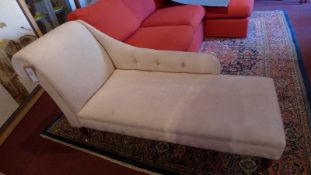 A Victorian style chaise longue upholstered in ivory floral fabric and raised on turned supports