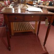 A 19th century mahogany writing table fitted two drawers and raised on turned supports.