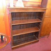 A Victorian oak open bookcase with adjustable shelves and on plinth base.