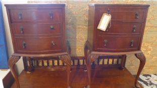 A pair of walnut bowfronted bedside tables fitted single drawer and panel door raised on cabriole