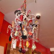 A contemporary designer five branch chandelier clad in various colourful fabrics and with cut glass