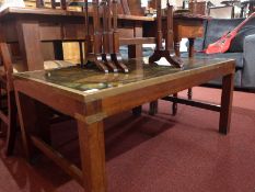 A 20th century mahogany low table of rectangular form with inset atlas print and with brass binding.