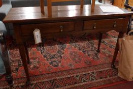 A 18th century oak side table fitted two drawers above feet cut frieze and raised on turned pad