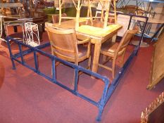 A vintage double bedstead clad in navy velour and with side rails.
