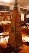 A 20th century hide covered and painted table lamp of obelisk form, with wrought iron frame.