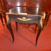 A French ebonised side table fitted single drawer raised on cabriole supports with gilt metal