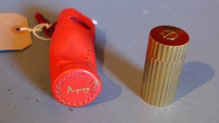 An Asprey brass miniature pepper grinder in branded leather sleeve