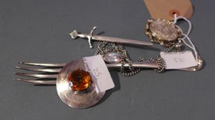 A 925 silver locket, a hallmarked silver sword form brooch,