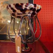 A Murano glass style pedestal bowl with black and white flecked detail.