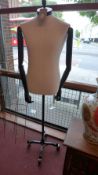 A pair of articulated mannequins / dressmakers dummies on cast iron stands