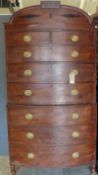 A Regency mahogany bowfronted chest on chest with inlaid cornice above an arrangement of eight