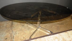 A Merrow Associates modern design chrome table with smoked glass top, 90cm x 112cm x 180cm