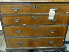An early 18th Century George I figured walnut and feather banded chest of four long graduated
