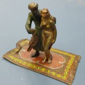 A Franz Bergman cold painted bronze figure group of a carpet seller with nude beside standing on a