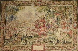 A Flemish design Verdu tapestry, depicting figures on horseback within floral border, 190cm x 130cm