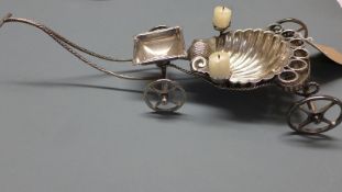 An early 20th Century Continental silver plated cigar table trolley, the shell form cart with hinged