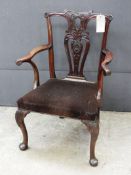 A Chippendale design mahogany open armchair, the carved splat back over studded stuff over brown