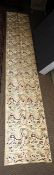 An antique Chinese silk wall hanging, c.1900, having metalwork dragon design 410cm x 70cm