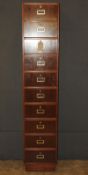 A mid-Century teak tall filing cabinet of ten drawers on plinth base, 40cm x 35cm x 198cm