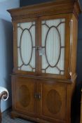 A Georgian design walnut and inlaid display cabinet, the lined glazed doors enclosing shelves over