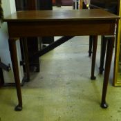 An early Georgian walnut side table, with drawers to either end, raised on turned legs and pad