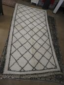 A genuine large Moroccan Berber (beni Ourain) rug, the twin lined geometric design on a white ground
