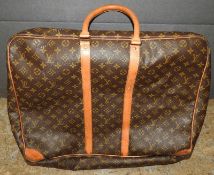 A designer Louis Vuitton leather travelling suitcase, having all over typical design 55cm x 45cm