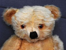 A Merrythought style 1950 teddy bear, lacking label, together with an English 1950 straw filled