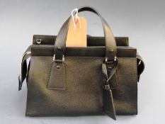 A brand new Armani designer black leather handbag having original cloth bag