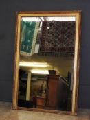 A large 19th Century design giltwood overmantel mirror, the rectangular plate within beaded frame,