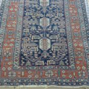 An antique Caucasian prepdiel rug the all over typical design with dragon motifs on midnight blue
