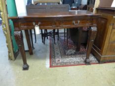 A 19th Century serving table, in the manner of Gillows, the serpentine front with two drawers,